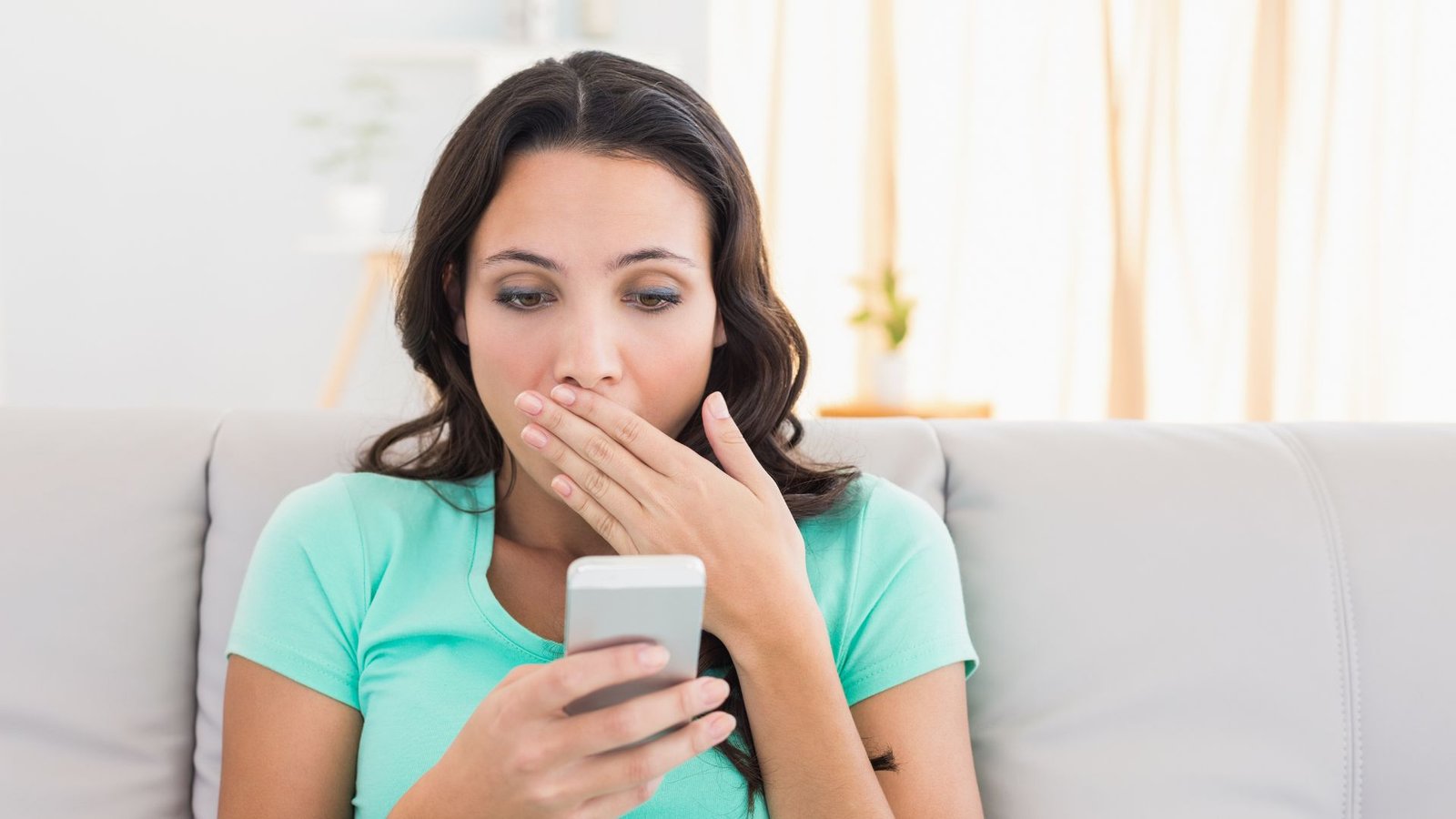 shocked woman reading a text - funniest auto-correct fails